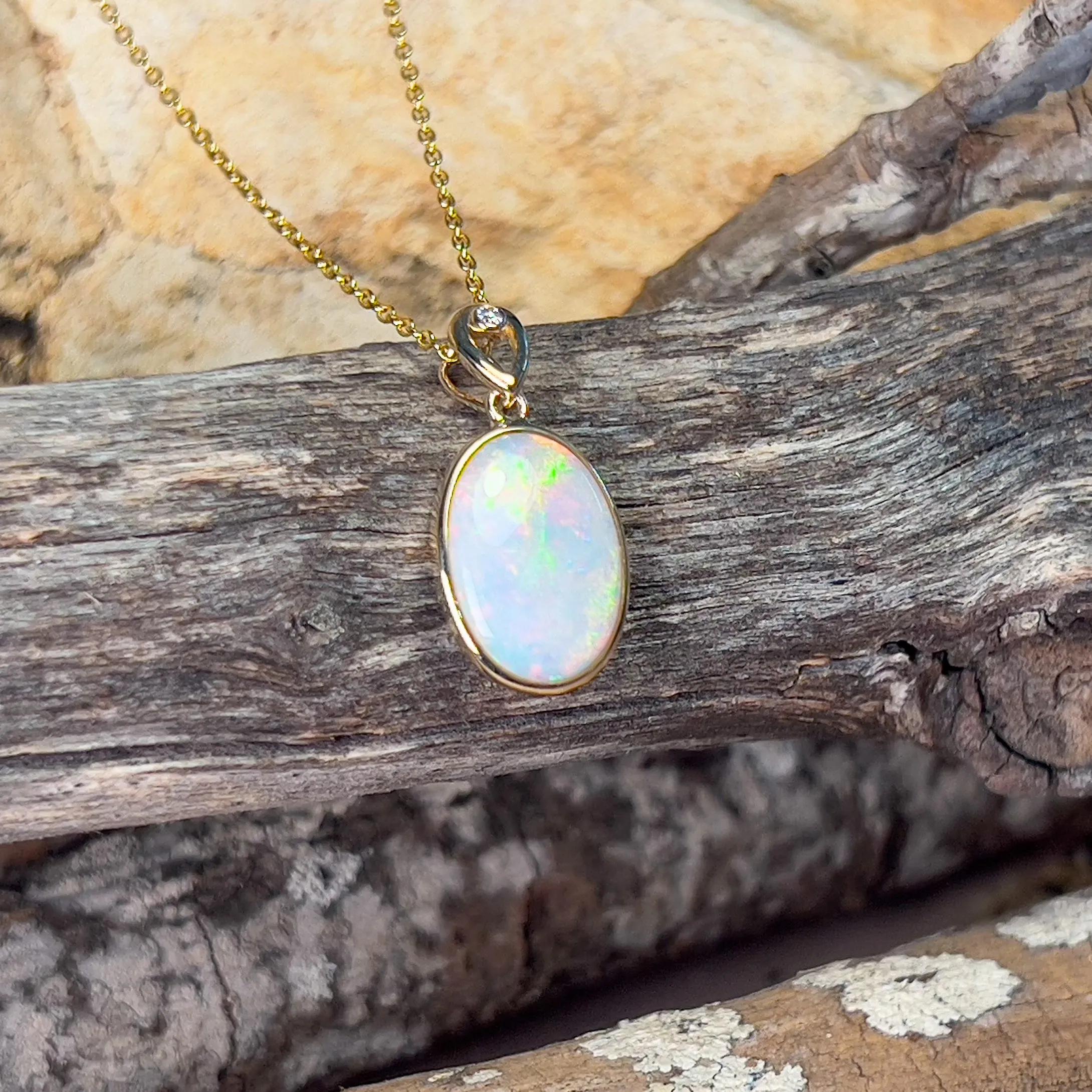 14kt Yellow Gold Oval White Opal Red 2.25ct bezel set pendant