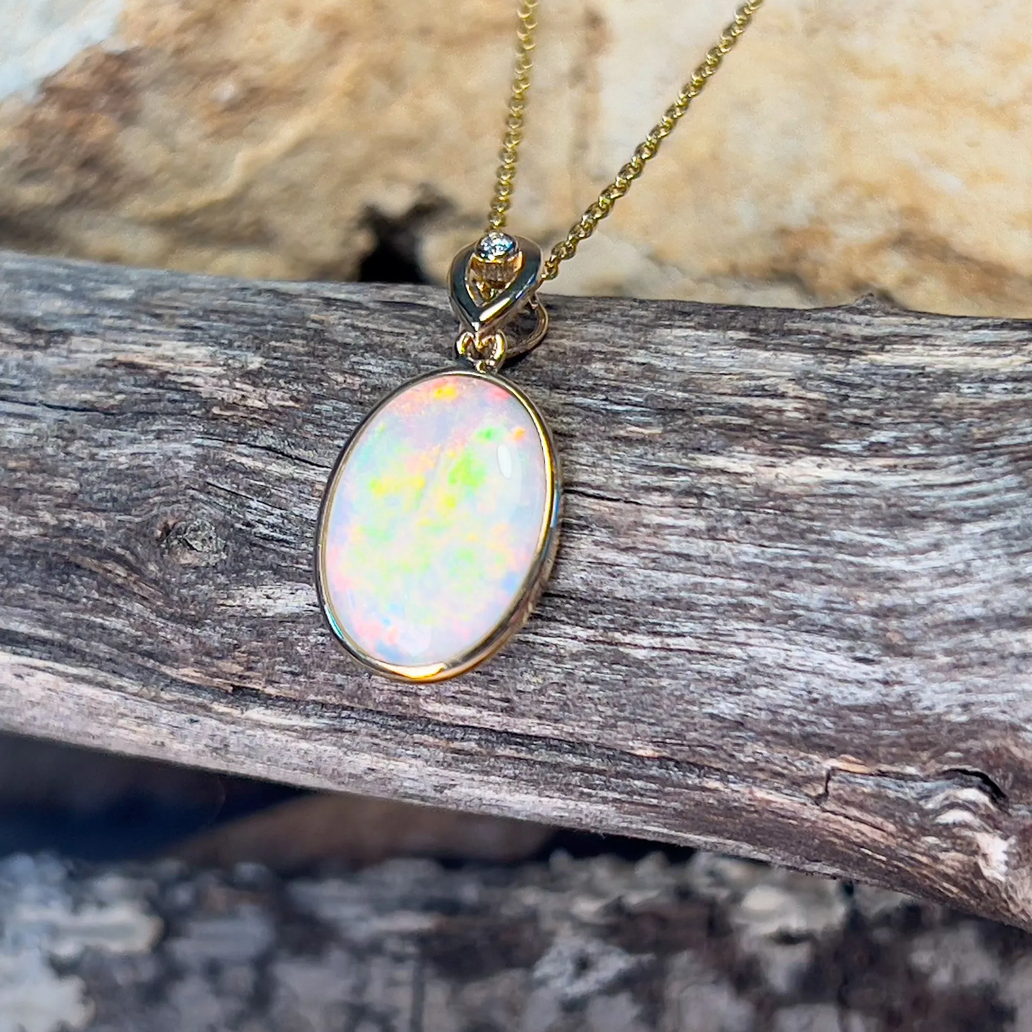 14kt Yellow Gold Oval White Opal Red 2.25ct bezel set pendant